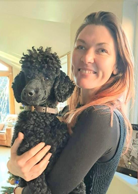Dr. Lauren Samet holding her black poodle